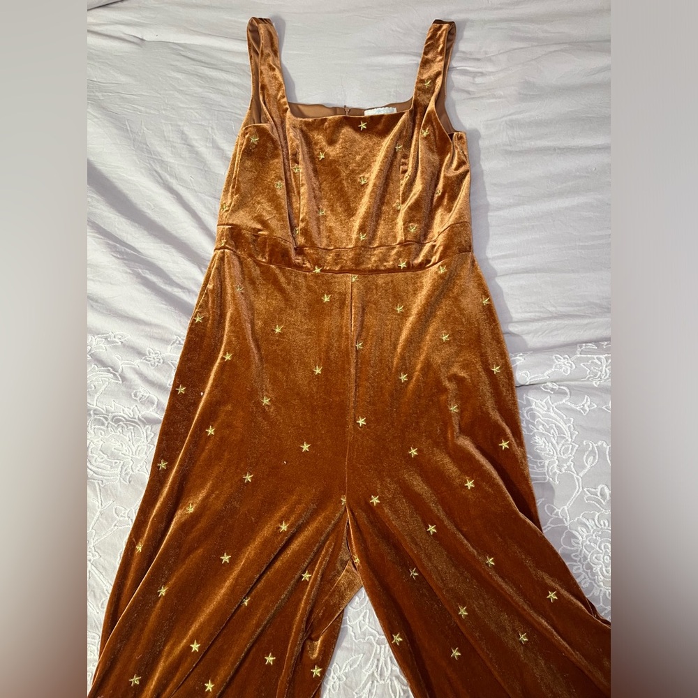 Francesca’s orange velour jumpsuit